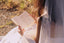 bride holding open wedding vow book with written vows